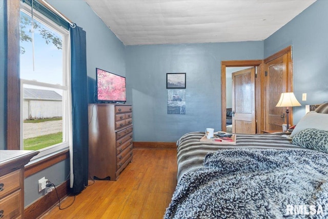 3292 110th St, Stockton, IA 52769 - bedroom with wood finished floors and multiple windows