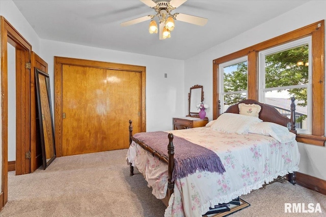 3292 110th St, Stockton, IA 52769 - bedroom with light carpet, a ceiling fan, and a closet