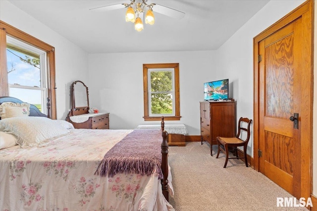 3292 110th St, Stockton, IA 52769 - carpeted bedroom featuring multiple windows and a ceiling fan
