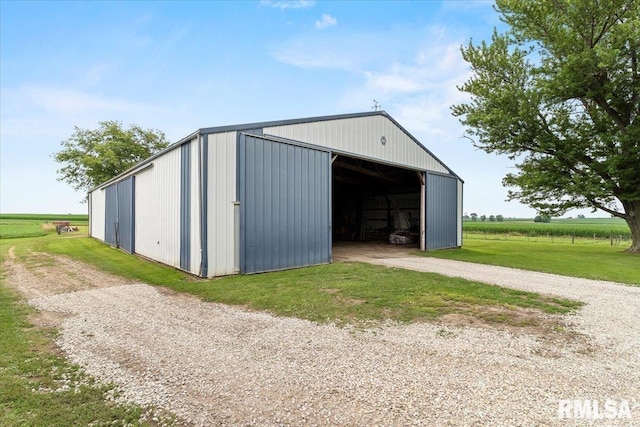 3292 110th St, Stockton, IA 52769 - view of pole building featuring driveway and a lawn