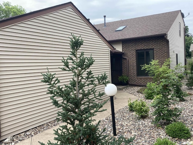 1862 53rd St, Moline, IL 61265 - view of side of property with brick siding and roof with shingles