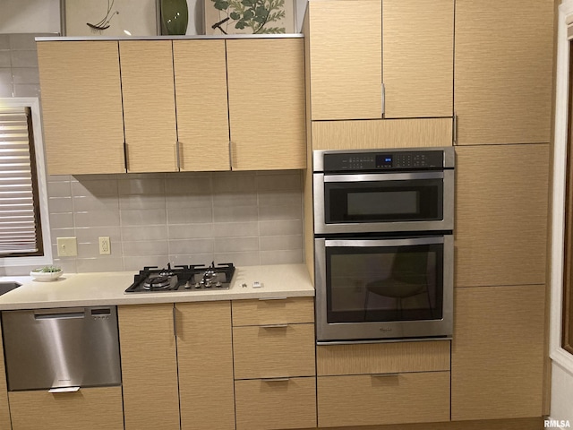 1862 53rd St, Moline, IL 61265 - kitchen with appliances with stainless steel finishes, light countertops, and backsplash