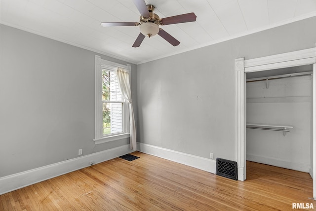 117 W 14th St, Davenport, IA 52803 - unfurnished bedroom featuring wood finished floors, ornamental molding, a closet, and ceiling fan
