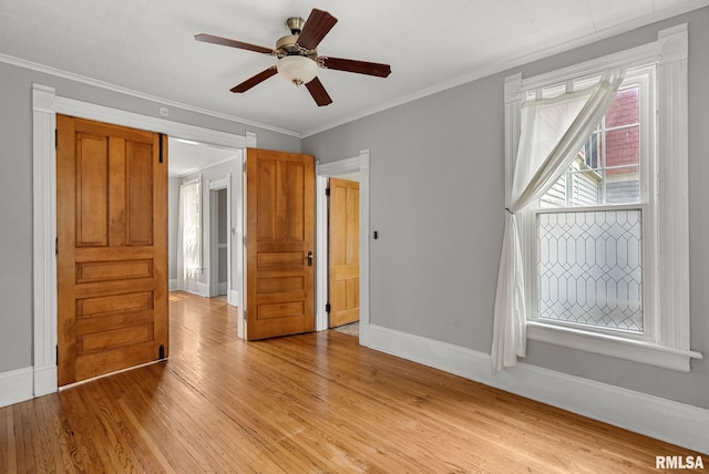117 W 14th St, Davenport, IA 52803 - unfurnished bedroom with light wood-style floors, crown molding, and a ceiling fan