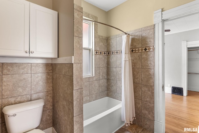 117 W 14th St, Davenport, IA 52803 - bathroom with shower / tub combo with curtain, tile walls, and wood finished floors