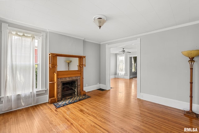 117 W 14th St, Davenport, IA 52803 - unfurnished living room with light wood finished floors, crown molding, a fireplace, and a ceiling fan