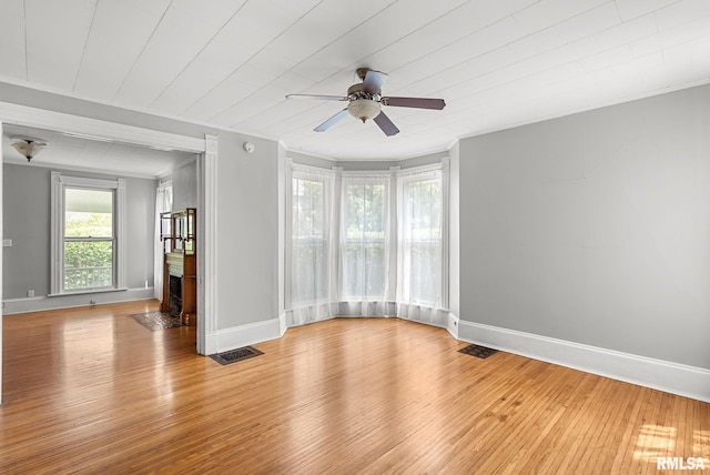 117 W 14th St, Davenport, IA 52803 - unfurnished room with a fireplace with flush hearth, ceiling fan, light wood finished floors, and ornamental molding