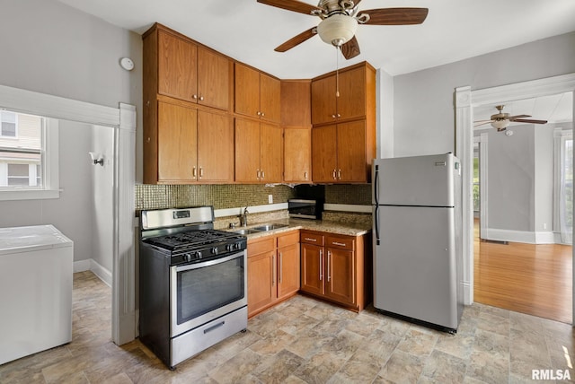 117 W 14th St, Davenport, IA 52803 - kitchen featuring appliances with stainless steel finishes, ceiling fan, backsplash, and plenty of natural light