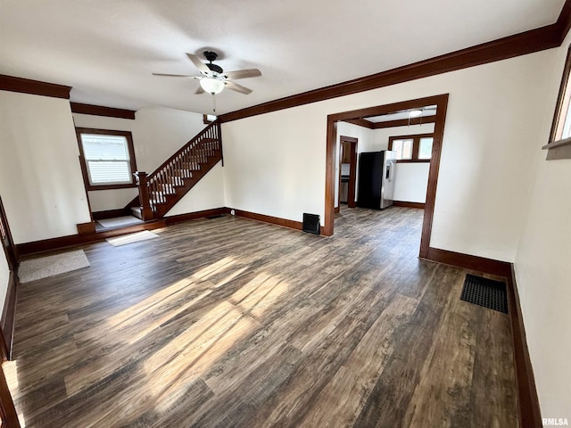 1820 13th St, Rock Island, IL 61201 - unfurnished living room featuring ornamental molding, dark wood finished floors, ceiling fan, and stairs