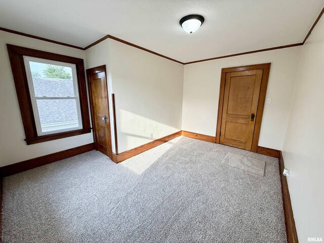1820 13th St, Rock Island, IL 61201 - carpeted spare room featuring baseboards and crown molding