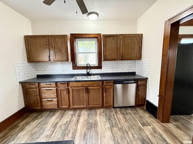 1820 13th St, Rock Island, IL 61201 - kitchen with dishwasher, dark countertops, wood finished floors, decorative backsplash, and ceiling fan