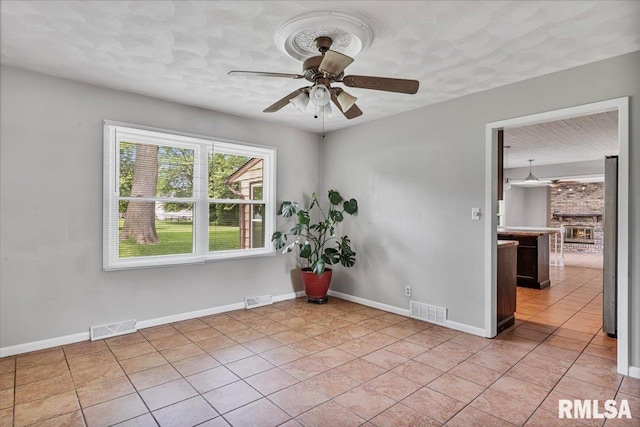 3611 75th St, Moline, IL 61265 - spare room with a ceiling fan, light tile patterned floors, and a textured ceiling