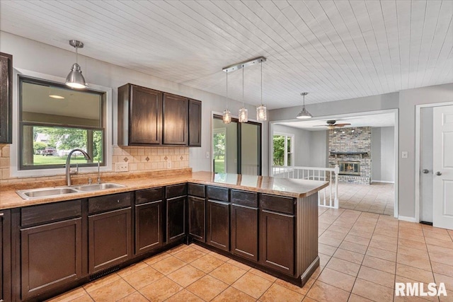 3611 75th St, Moline, IL 61265 - kitchen featuring light tile patterned floors, dark brown cabinets, tasteful backsplash, light countertops, and wood ceiling