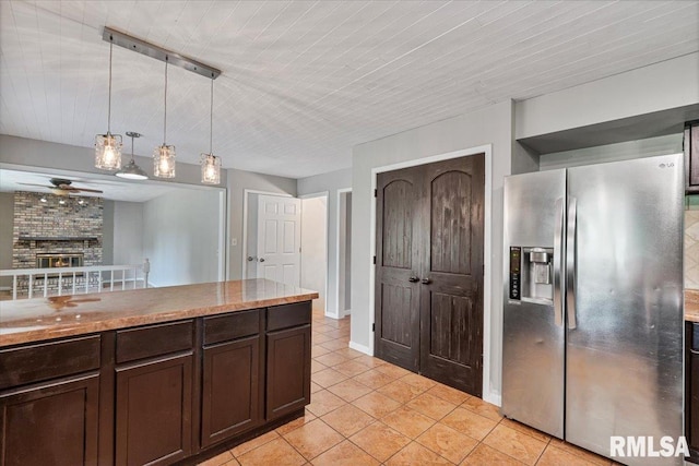 3611 75th St, Moline, IL 61265 - kitchen with stainless steel fridge with ice dispenser, ceiling fan, dark brown cabinets, light tile patterned flooring, and a fireplace