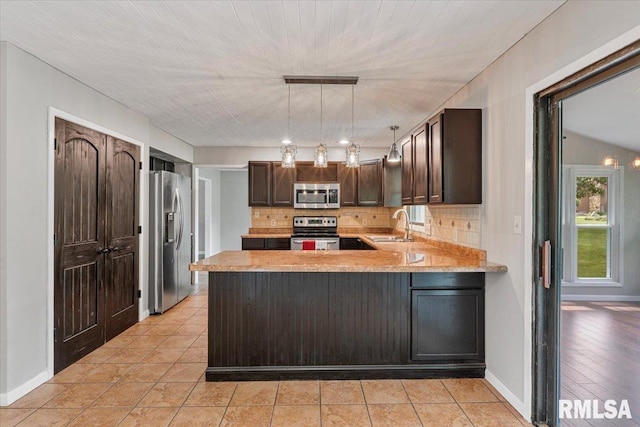 3611 75th St, Moline, IL 61265 - kitchen with appliances with stainless steel finishes, backsplash, light countertops, and a peninsula