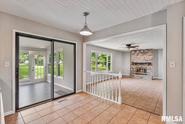 3611 75th St, Moline, IL 61265 - doorway with light tile patterned flooring, a ceiling fan, and a brick fireplace