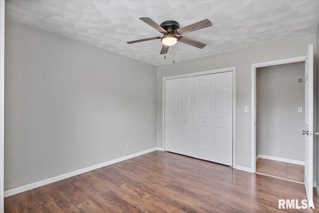 3611 75th St, Moline, IL 61265 - unfurnished bedroom featuring a closet, wood finished floors, and a ceiling fan