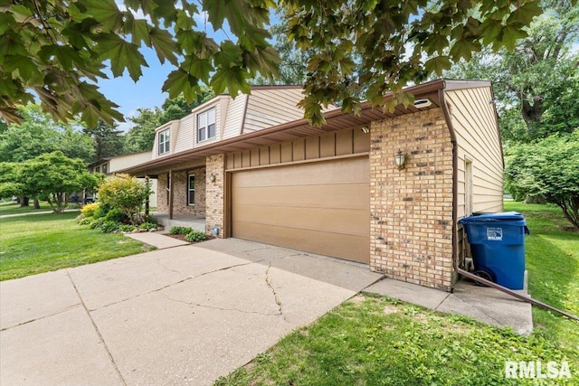 3611 75th St, Moline, IL 61265 - view of front facade with brick siding, a front yard, driveway, and a garage