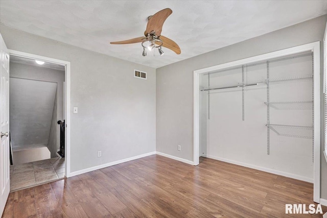 3611 75th St, Moline, IL 61265 - unfurnished bedroom featuring wood finished floors, a closet, and ceiling fan