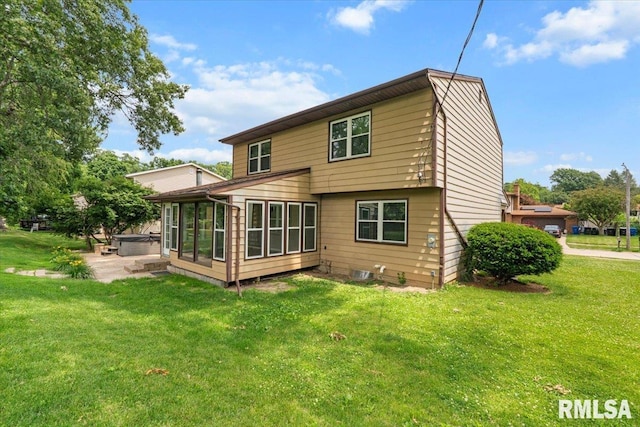 3611 75th St, Moline, IL 61265 - back of house with a hot tub, a sunroom, a yard, and a patio