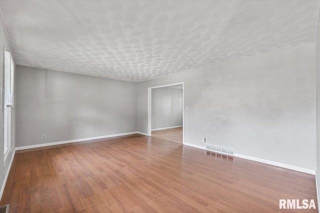 3611 75th St, Moline, IL 61265 - spare room featuring wood finished floors and baseboards