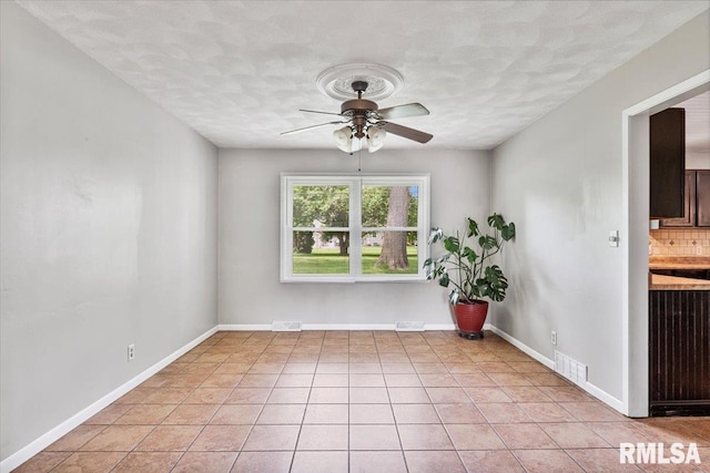 3611 75th St, Moline, IL 61265 - spare room featuring ceiling fan, light tile patterned floors, and a textured ceiling