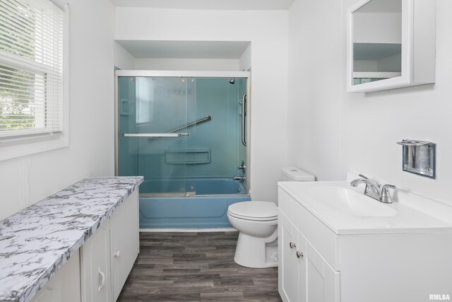 320 16th Ave N, Clinton, IA 52732 - bathroom featuring wood finished floors, vanity, and shower / bath combination with glass door