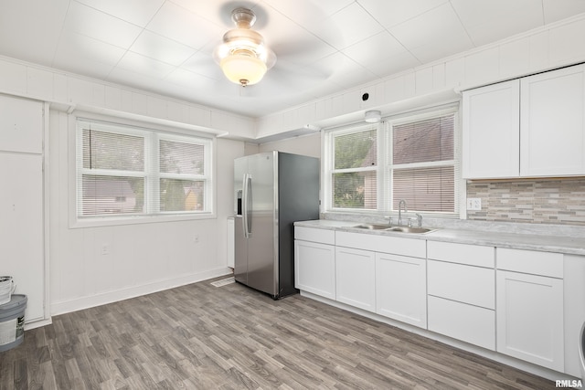 320 16th Ave N, Clinton, IA 52732 - kitchen featuring stainless steel refrigerator with ice dispenser, healthy amount of natural light, white cabinetry, and crown molding