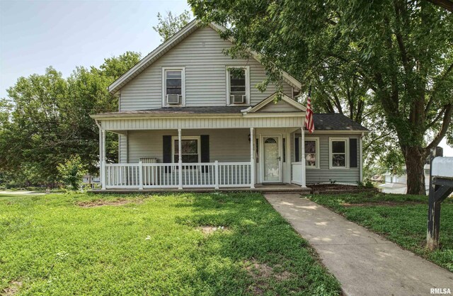828 10th Ave, Fulton, IL 61252 - view of front of house featuring a porch, a front lawn, and cooling unit