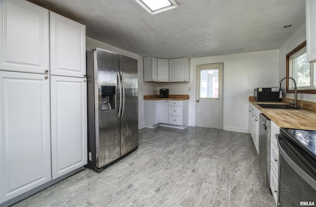 828 10th Ave, Fulton, IL 61252 - kitchen with stainless steel appliances, wood counters, and white cabinetry
