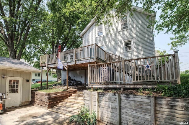 828 10th Ave, Fulton, IL 61252 - back of property featuring a deck, stairway, and a patio