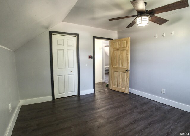 828 10th Ave, Fulton, IL 61252 - unfurnished bedroom with dark wood-style flooring, vaulted ceiling, ceiling fan, and a closet