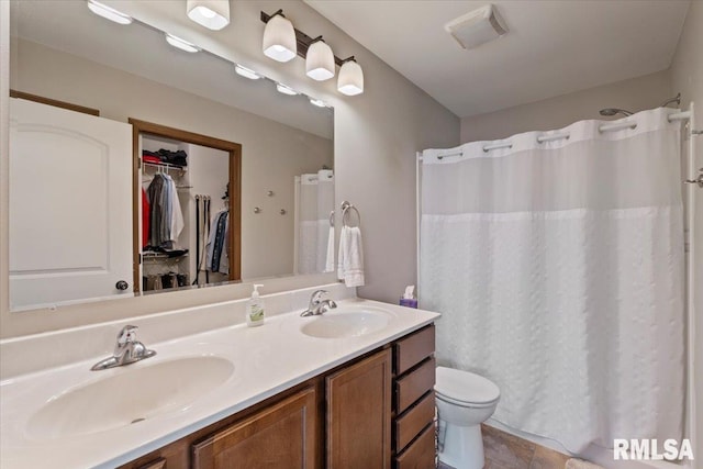 6234 Mississippi Ave, Davenport, IA 52807 - bathroom featuring double vanity, a walk in closet, a shower with shower curtain, and tile patterned flooring