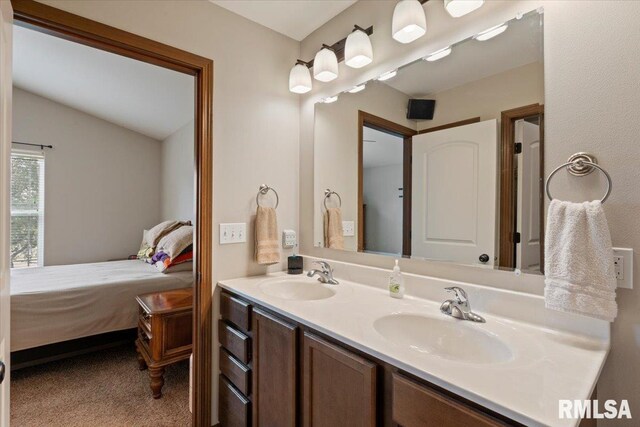6234 Mississippi Ave, Davenport, IA 52807 - bathroom with ensuite bathroom, double vanity, and vaulted ceiling