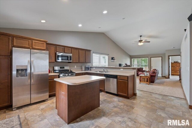 6234 Mississippi Ave, Davenport, IA 52807 - kitchen with stainless steel appliances, a kitchen island, light countertops, ceiling fan, and high vaulted ceiling