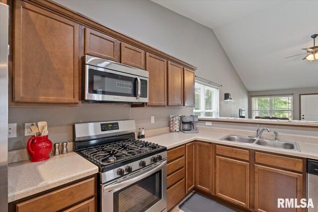 6234 Mississippi Ave, Davenport, IA 52807 - kitchen featuring stainless steel appliances, lofted ceiling, brown cabinets, light countertops, and ceiling fan