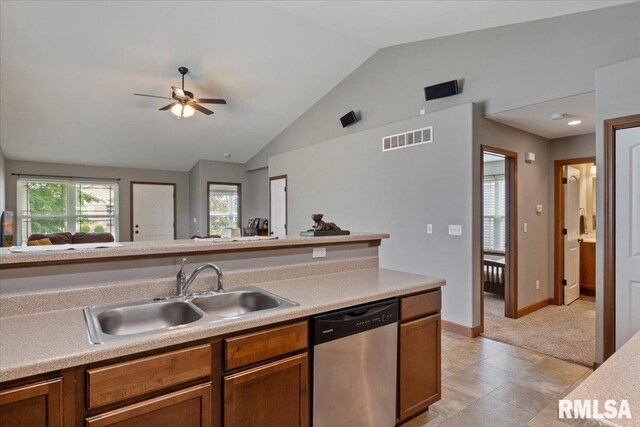 6234 Mississippi Ave, Davenport, IA 52807 - kitchen featuring stainless steel dishwasher, vaulted ceiling, ceiling fan, brown cabinets, and light countertops