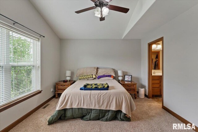 6234 Mississippi Ave, Davenport, IA 52807 - bedroom featuring vaulted ceiling, carpet, ensuite bath, and a ceiling fan