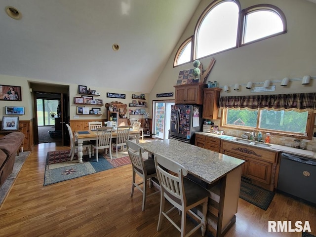 313 Double C Farm Ln, Dongola, IL 62964 - kitchen featuring dishwasher, refrigerator with ice dispenser, high vaulted ceiling, light wood-style floors, and healthy amount of natural light