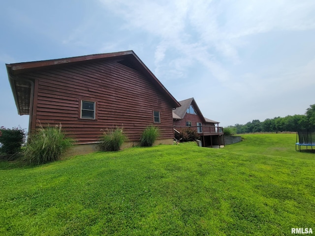 313 Double C Farm Ln, Dongola, IL 62964 - view of side of property featuring a trampoline, a yard, and a wooden deck
