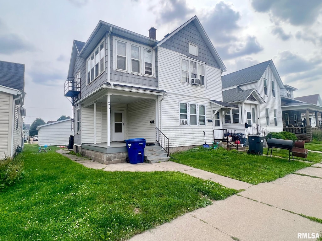 423 6th Ave N, Clinton, IA 52732 - back of property featuring a lawn, a chimney, and a balcony