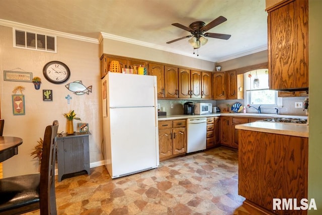 705 S Hadfield St, Marion, IL 62959 - kitchen featuring white appliances, a ceiling fan, brown cabinetry, light countertops, and ornamental molding