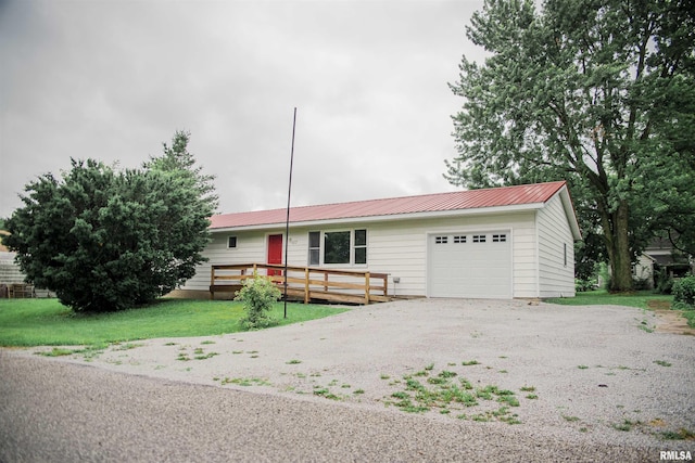 107 N 1st St, West Point, IL 62380 - ranch-style house featuring an attached garage, a metal roof, driveway, and a front yard