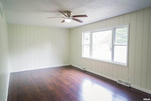 107 N 1st St, West Point, IL 62380 - empty room with dark wood-style floors, a ceiling fan, and a textured ceiling