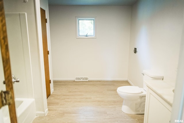 107 N 1st St, West Point, IL 62380 - full bath featuring vanity, wood finished floors, and a tub