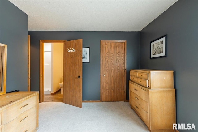 4725 Kynnelworth Dr Unit 8, Bettendorf, IA 52722 - bedroom with light colored carpet, a closet, and connected bathroom