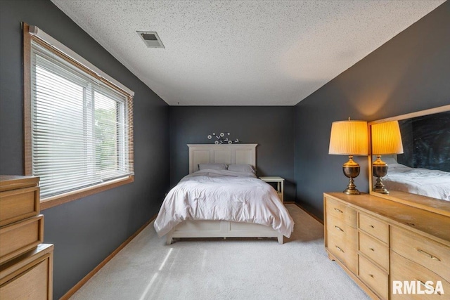 4725 Kynnelworth Dr Unit 8, Bettendorf, IA 52722 - bedroom featuring light carpet and a textured ceiling