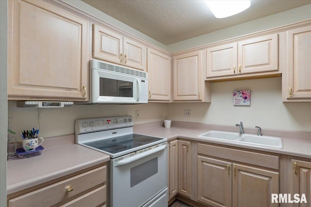 4725 Kynnelworth Dr Unit 8, Bettendorf, IA 52722 - kitchen with white appliances, light countertops, a textured ceiling, and light brown cabinetry