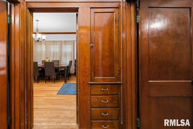 2531 5th St, Moline, IL 61265 - corridor with a chandelier and light wood-style flooring