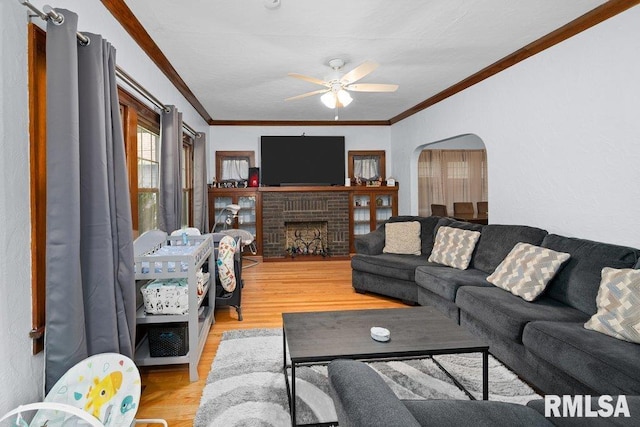 2531 5th St, Moline, IL 61265 - living room with ceiling fan, wood finished floors, ornamental molding, arched walkways, and a fireplace